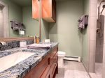 Master bathroom has two sinks and a walk in shower